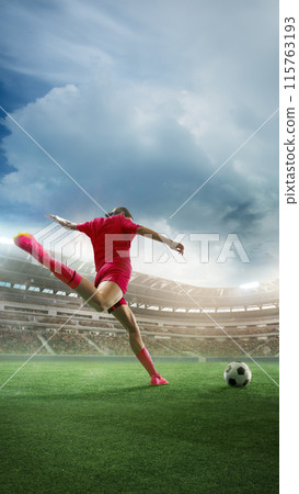 Vertical image of woman, soccer player in red uniform during match hitting ball, scoring goal. 3D render of stadium with fans tribune Vertical image of woman, soccer player in red uniform during match hitting ball, scoring goal. 3D render of stadium with fans tribune 115763193