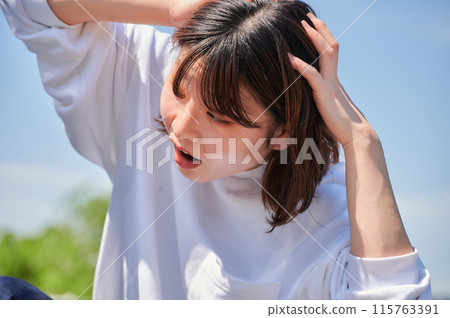 Woman holding her head in front of her car, flat tire, trouble Woman holding her head in front of her car, flat tire, trouble 115763391