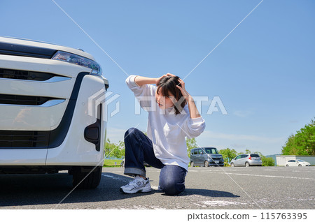 Woman holding her head in front of her car, flat tire, trouble Woman holding her head in front of her car, flat tire, trouble 115763395