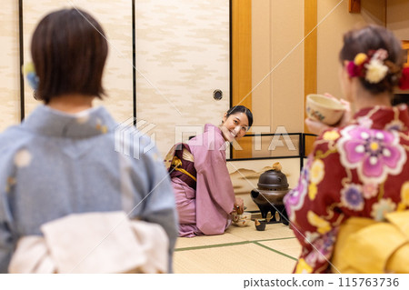 Foreign female tourists in kimonos experiencing a tea ceremony and a Japanese female guide Foreign female tourists in kimonos experiencing a tea ceremony and a Japanese female guide 115763736