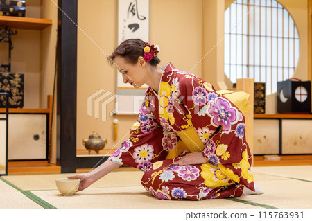 Foreign female tourists in kimonos enjoying a tea ceremony experience Foreign female tourists in kimonos enjoying a tea ceremony experience 115763931
