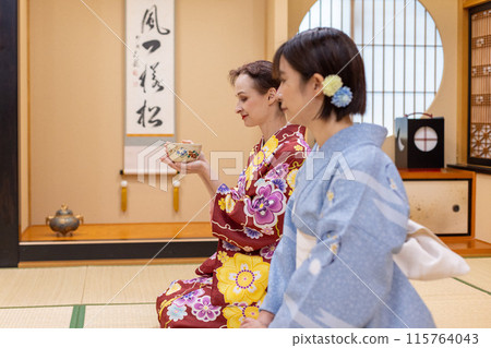 Foreign female tourists and Japanese women in kimonos enjoying a tea ceremony experience Foreign female tourists and Japanese women in kimonos enjoying a tea ceremony experience 115764043