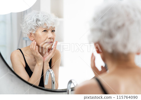 Senior women with skin problems 115764090