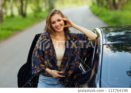 Happy woman driver at car smiling. Cute young happy brunette female driving car vehicle 115764196