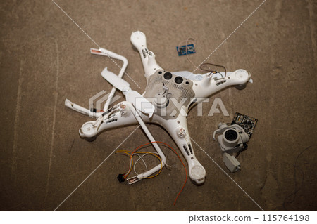 Fallen damaged quadcopter drone crash on a floor. Fallen damaged quadcopter drone crash on a floor. 115764198
