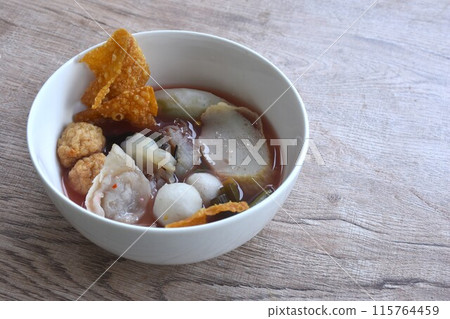 boiled fish and shrimp ball couple dumpling topping pickled cuttlefish in red soybean sauce soup on bowl 115764459