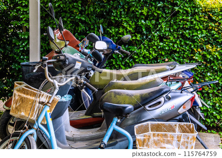 Yokohama cityscape in Japan: A motorcycle left abandoned in a corner covered in dust 115764759