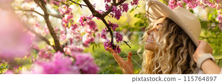 Beautiful woman in sunglasses near blossoming tree on spring day, space for text banner 115764897
