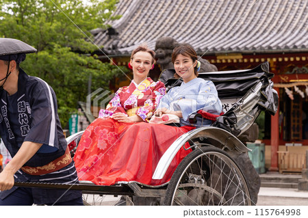 A foreign woman and a Japanese woman in kimono sightseeing in Asakusa on a rickshaw A foreign woman and a Japanese woman in kimono sightseeing in Asakusa on a rickshaw 115764998