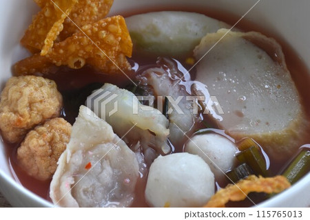 boiled fish and shrimp ball couple dumpling topping pickled cuttlefish in red soybean sauce soup on bowl 115765013