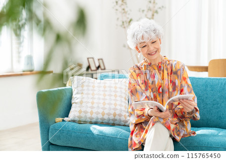 Senior woman relaxing in the living room 115765450
