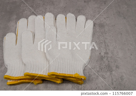 Anti-slip gloves lined up on concrete Anti-slip gloves lined up on concrete 115766007