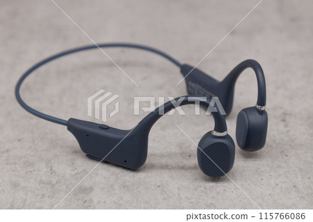 Bluetooth earphones on concrete Bluetooth earphones on concrete 115766086