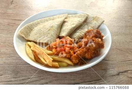 Quesadilla Mexican pizza stuffing mashed spicy chicken with French fries and barbecue buffalos wing topping sour salad on plate Quesadilla Mexican pizza stuffing mashed spicy chicken with French fries and barbecue buffalos wing topping sour salad on plate 115766088