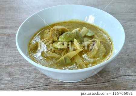 spicy boiled slice fresh bamboo shoot with chicken topping stink bean in coconut milk curry soup on bowl spicy boiled slice fresh bamboo shoot with chicken topping stink bean in coconut milk curry soup on bowl 115766091