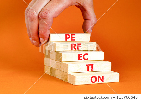 Perfection symbol. Concept word Perfection on beautiful wooden blocks. Businessman hand. Beautiful orange background. Business perfection concept. Copy space. 115766643