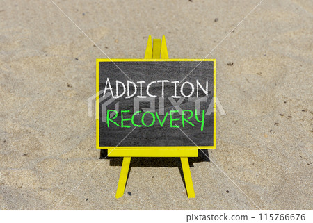 Addiction recovery symbol. Concept words Addiction recovery on beautiful black chalk blackboard. Beautiful sand sea beach background. Psychology addiction recovery concept. Copy space. 115766676