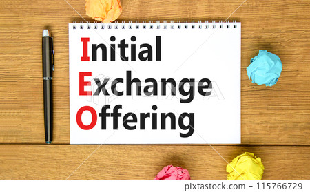 IEO initial exchange offering symbol. Concept words IEO initial exchange offering on beautiful note. Beautiful wooden table background. Business IEO initial exchange offering concept. Copy space. 115766729