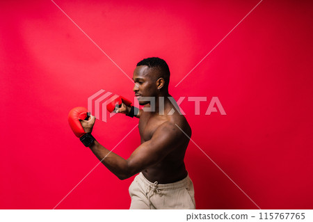 Young attractive African American male boxer with bare torso, muscular body. Concept of training Young attractive African American male boxer with bare torso, muscular body. Concept of training 115767765