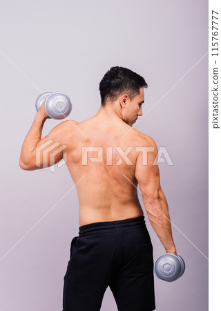 Shirtless bodybuilder showing his great body and holding dumbell. 115767777