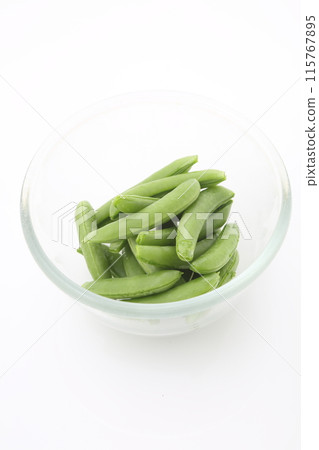 Stripped snap peas in glass bowl high angle Stripped snap peas in glass bowl high angle 115767895