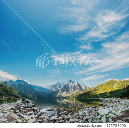 Tatra National Park, Poland. Panorama Famous Mountains Lake Morskie Oko Or Sea Eye Lake In Summer Morning. Five Lakes Valley. Beautiful Scenic Viev Tatra National Park, Poland. Panorama Famous Mountains Lake Morskie Oko Or Sea Eye Lake In Summer Morning. Five Lakes Valley. Beautiful Scenic Viev 115768090