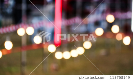 A vintage light bulb glows beautifully at night, casting a warm, soft light that creates a cozy atmosphere. 115768149