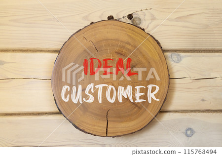 Ideal customer symbol. Concept words Ideal customer on beautiful wooden circle. Beautiful wooden wall background. Business ideal customer concept. Copy space. 115768494