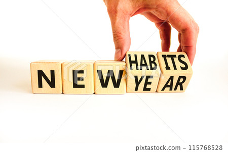 New year and habits symbol. Concept word New year New habits on wooden cubes. Beautiful white table white background. Psychologist hand. Psychological new year and habits concept. Copy space. 115768528