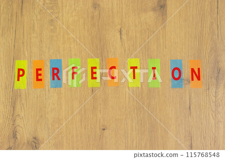 Perfection symbol. Concept word Perfection on beautiful colored paper. Beautiful wooden background. Business perfection concept. Copy space. 115768548