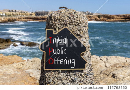 IPO initial public offering symbol. Concept words IPO initial public offering on beautiful yellow blackboard. Beautiful stone sea background. Business IPO initial public offering concept. Copy space. 115768560