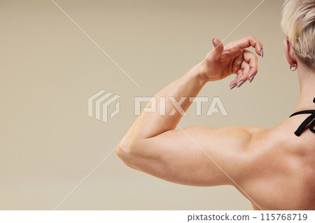 Cropped close up on unrecognizable strong sportswomans arm. Cropped close up on unrecognizable strong sportswomans arm. 115768719
