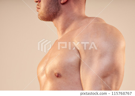 Cropped side view shot of unrecognizable pumped sportsman with strong chest and shoulder muscles isolated on neutral background, copy space Cropped side view shot of unrecognizable pumped sportsman with strong chest and shoulder muscles isolated on neutral background, copy space 115768767
