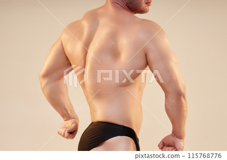 Shot of strong sportsmans back muscles. Personal fitness trainer sideways to camera showing pumped back and arm musculature isolated on neutral background, copy space Shot of strong sportsmans back muscles. Personal fitness trainer sideways to camera showing pumped back and arm musculature isolated on neutral background, copy space 115768776