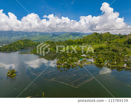 Mountain with rainforest sorrounded in Lake Sebu. Blue sky and clouds. Mindanao, Philippines. 115769139