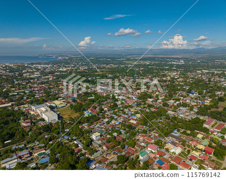 Cityscape: General Santos City, beautiful urban city at daytime. Blue sky and clouds. Mindanao, Philippines. Cityscape: General Santos City, beautiful urban city at daytime. Blue sky and clouds. Mindanao, Philippines. 115769142