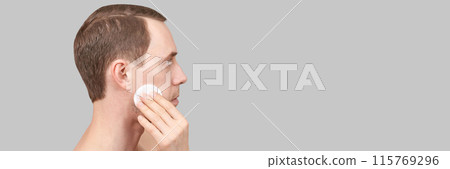 Man doing home skin care routine. Cotton pad. Dermatology treatment. Cream Man doing home skin care routine. Cotton pad. Dermatology treatment. Cream 115769296