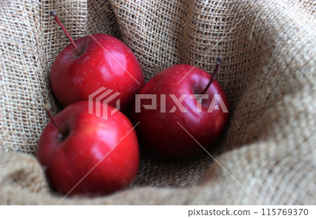 Freshly Picked Domestic Red Apples On Craft Burlap Fabric Stock Photo Freshly Picked Domestic Red Apples On Craft Burlap Fabric Stock Photo 115769370