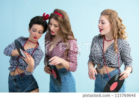Three retro girls with vinyl records. Three retro girls with vinyl records. 115769648