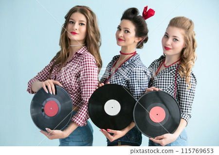 Retro women pose with musical vinyl records 115769653