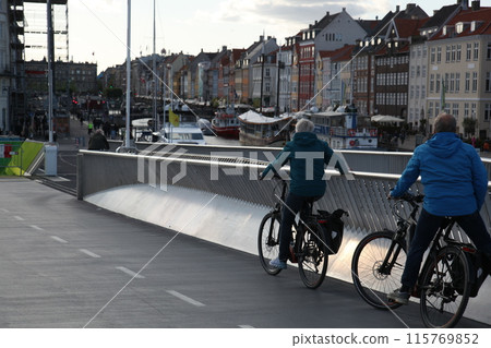 Old couple resting on the bridge while riding bicycles Old couple resting on the bridge while riding bicycles 115769852