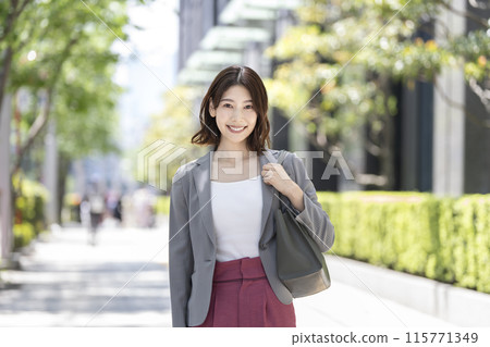 A business woman in her thirties smiling at the camera A business woman in her thirties smiling at the camera 115771349