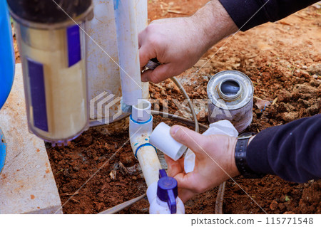 Water is being connected to well system to pump water to house Water is being connected to well system to pump water to house 115771548