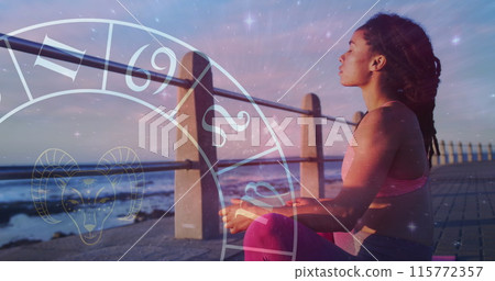 Horoscope circle and stars against african american fit woman meditating on the promenade 115772357