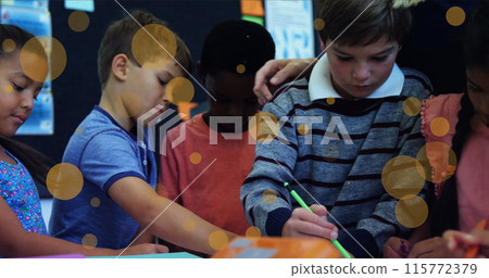 Image of yellow spots over diverse schoolchildren drawing with teacher Image of yellow spots over diverse schoolchildren drawing with teacher 115772379