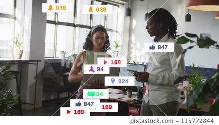 Image of notification bars over diverse coworkers standing and discussing reports on laptop 115772844