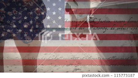 Image of American flag waving and constitution text over biracial couple by seaside on summer holida Image of American flag waving and constitution text over biracial couple by seaside on summer holida 115773187