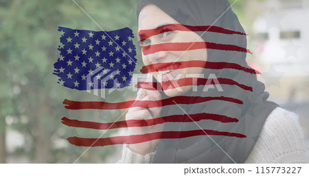 Image of American flag drawn over biracial woman in hijab talking on her smartphone in the backgroun Image of American flag drawn over biracial woman in hijab talking on her smartphone in the backgroun 115773227
