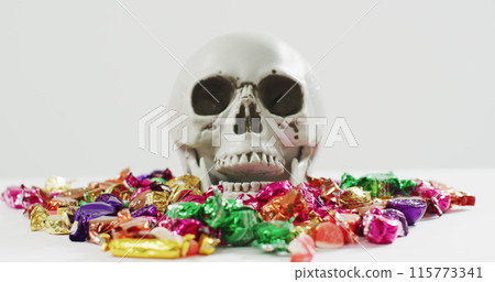 Image of happy halloween text over skull and sweets Image of happy halloween text over skull and sweets 115773341