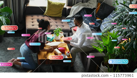 Image of social media notifications over diverse couple wrapping presents 115773961